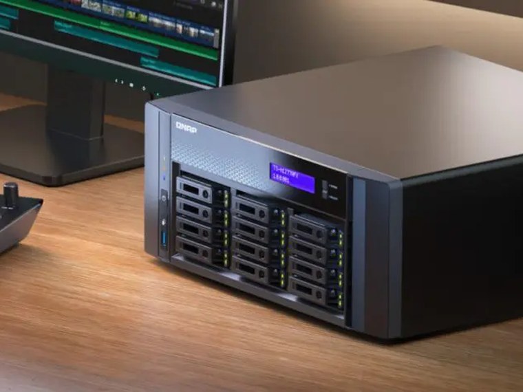 A rack-style NAS beside an edit workstation