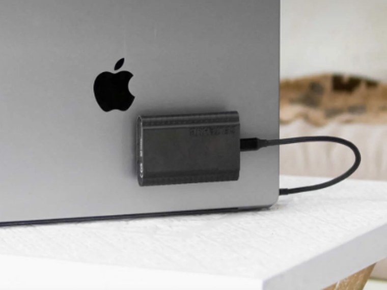 A portable SSD plugged into a MacBook